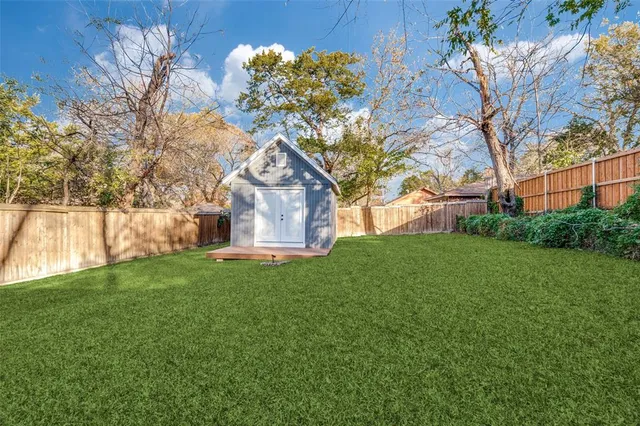 a view of a backyard with large trees