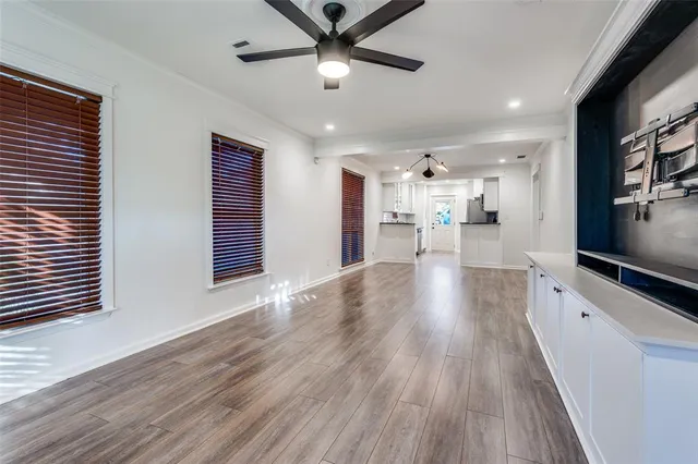 a view of a kitchen with wooden floor and a window
