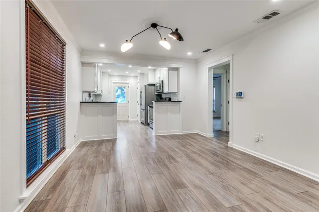 a view of a kitchen with wooden floor and a kitchen