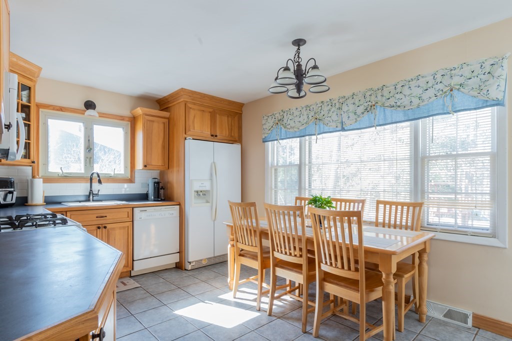 115 Ridgewood Road New Bedford, MA 02745 - Photo 16 of 28 a dining room with furniture a chandelier and window