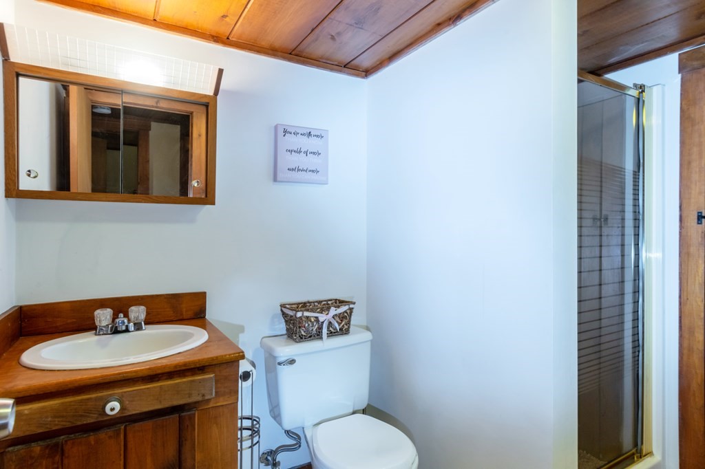115 Ridgewood Road New Bedford, MA 02745 - Photo 26 of 28 a bathroom with a toilet a sink and mirror