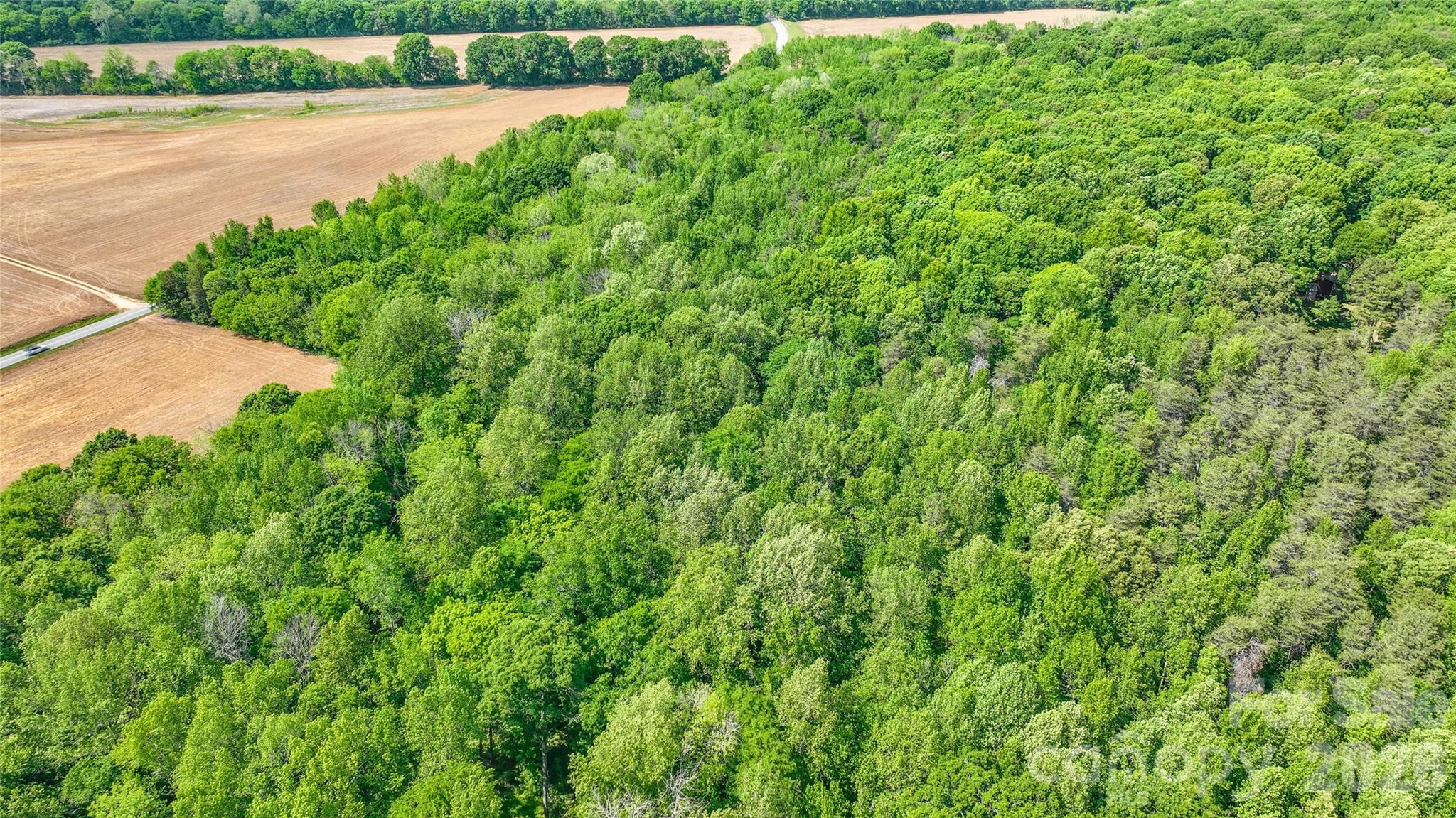 0 McIntyre Road, Unit 1 2 3 4 5 Wingate, NC 28174 - Photo 20 of 25 a view of a garden with a lake view