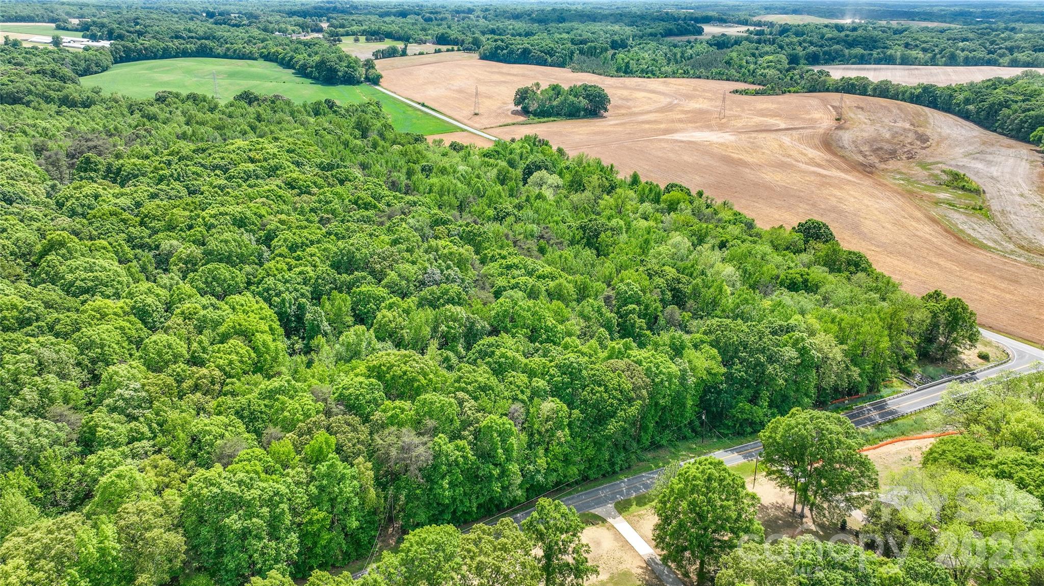0 McIntyre Road, Unit 1 2 3 4 5 Wingate, NC 28174 - Photo 21 of 25 an aerial view of residential house with outdoor space and trees all around