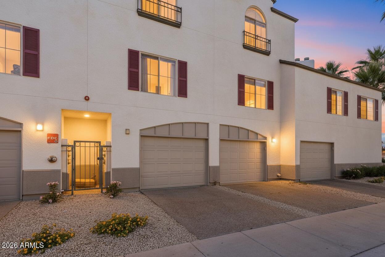 100 East Fillmore Street, Unit 216 Phoenix, AZ 85004 - Photo 16 of 36 a front view of a house with a garage