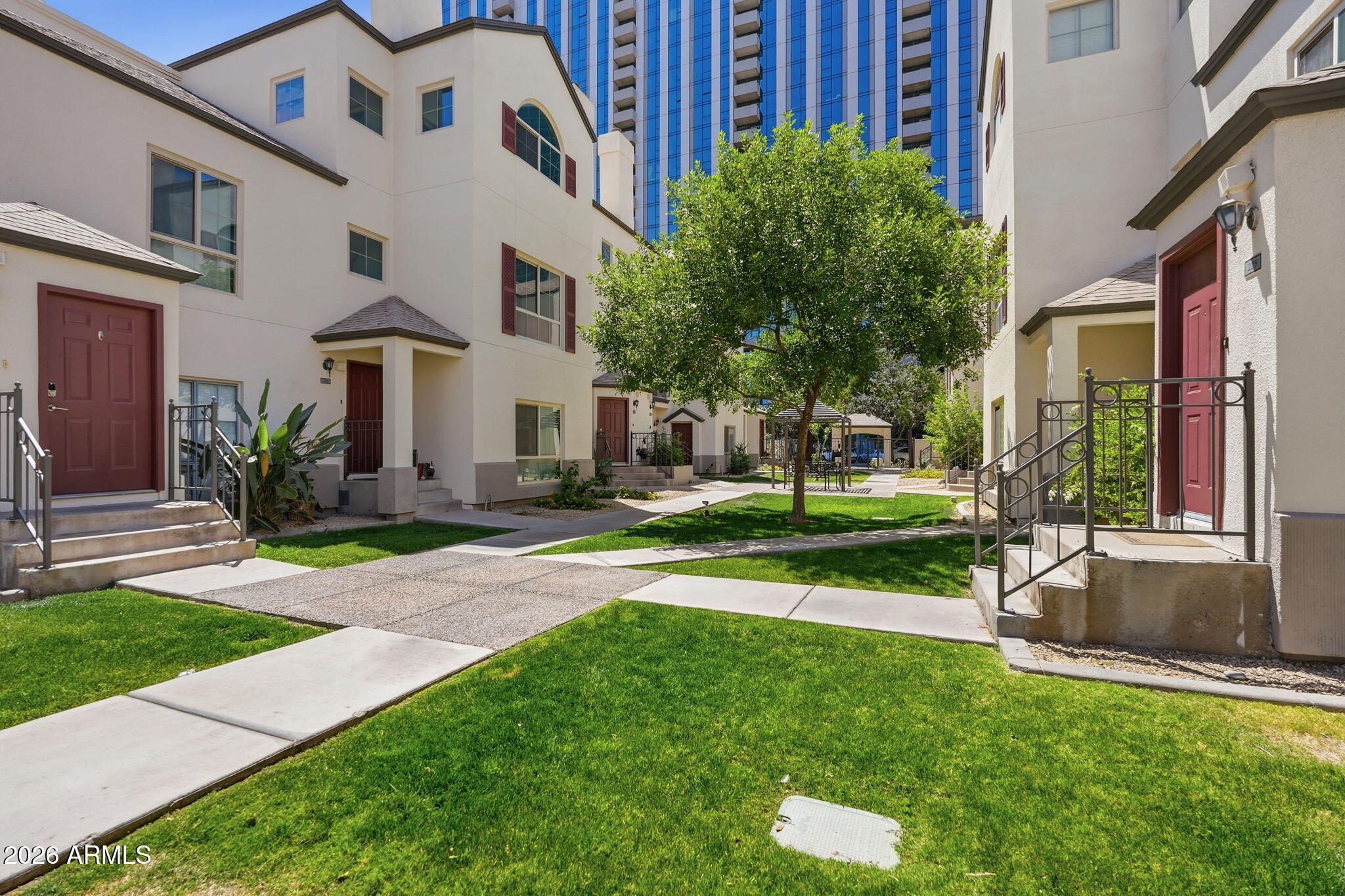 100 East Fillmore Street, Unit 216 Phoenix, AZ 85004 - Photo 20 of 36 a view of a building with a yard