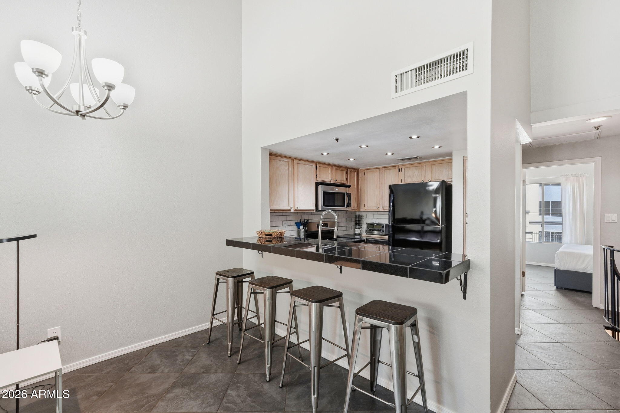 100 East Fillmore Street, Unit 216 Phoenix, AZ 85004 - Photo 5 of 36 a kitchen with stainless steel appliances granite countertop a sink and a refrigerator
