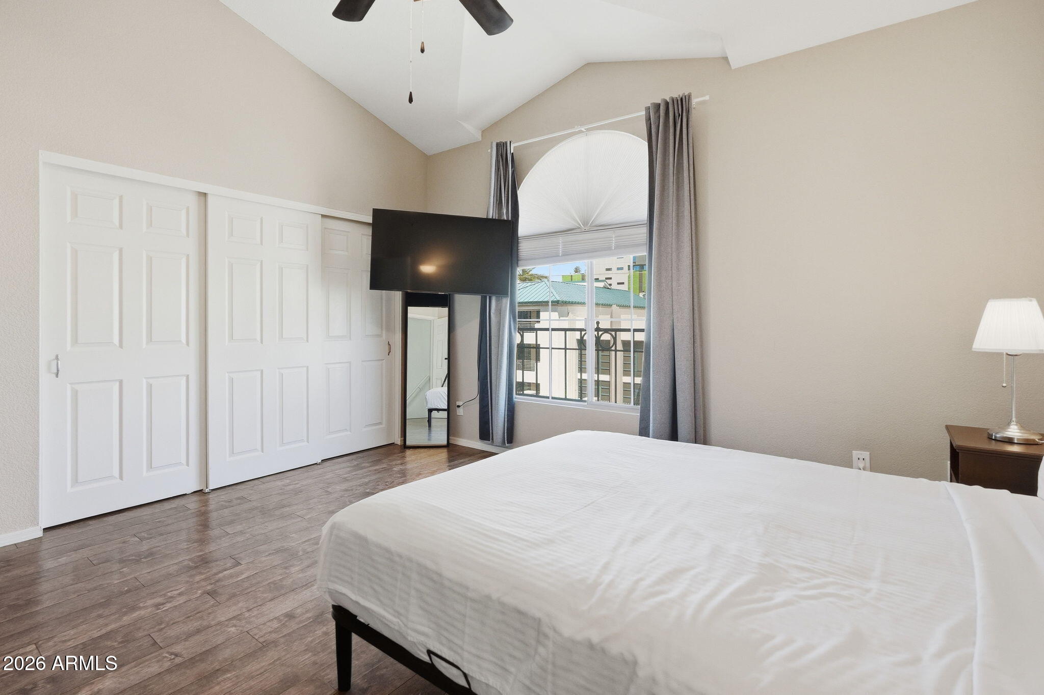 100 East Fillmore Street, Unit 216 Phoenix, AZ 85004 - Photo 9 of 36 a bedroom with a bed and a large window