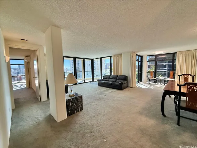 a living room with furniture and a lamp