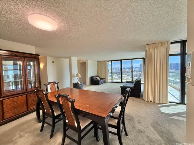 a view of a dining room with furniture and window
