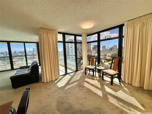 a living room with furniture and a floor to ceiling window