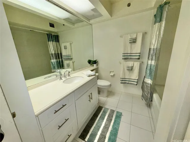 a bathroom with a double vanity sink toilet and shower