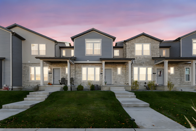 3473 Hardman Way Lehi, UT 84048 - Photo 3 of 22 View of front of house featuring stone siding, a front yard, and a porch