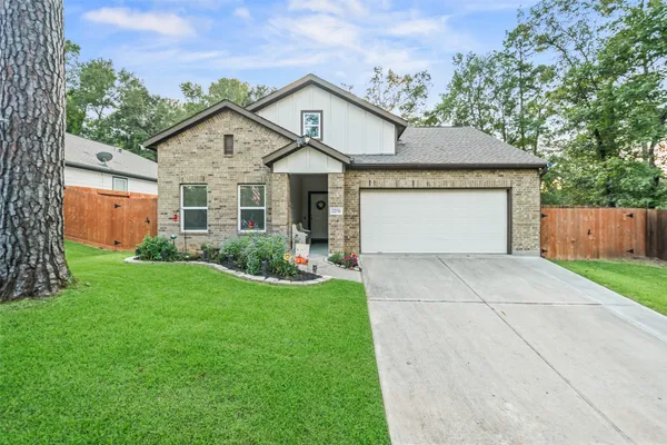 a front view of house with yard and green space