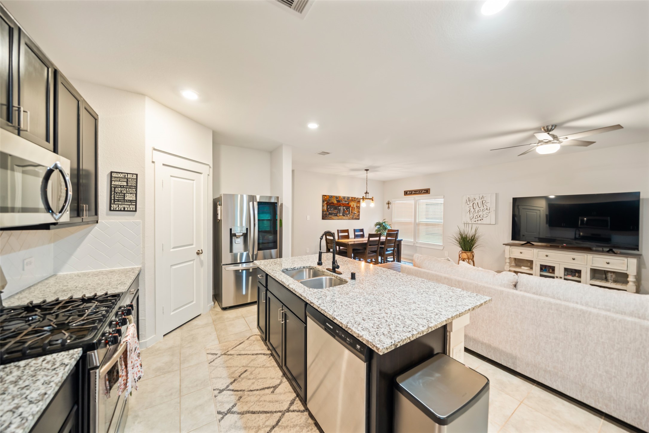 12158 Mustang Avenue Willis, TX 77378 - Photo 13 of 36 a kitchen with a stove a sink and a refrigerator