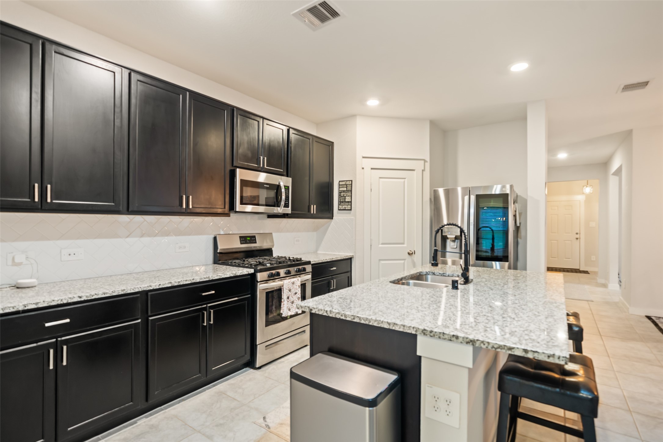 12158 Mustang Avenue Willis, TX 77378 - Photo 17 of 36 a kitchen with granite countertop stainless steel appliances and sink