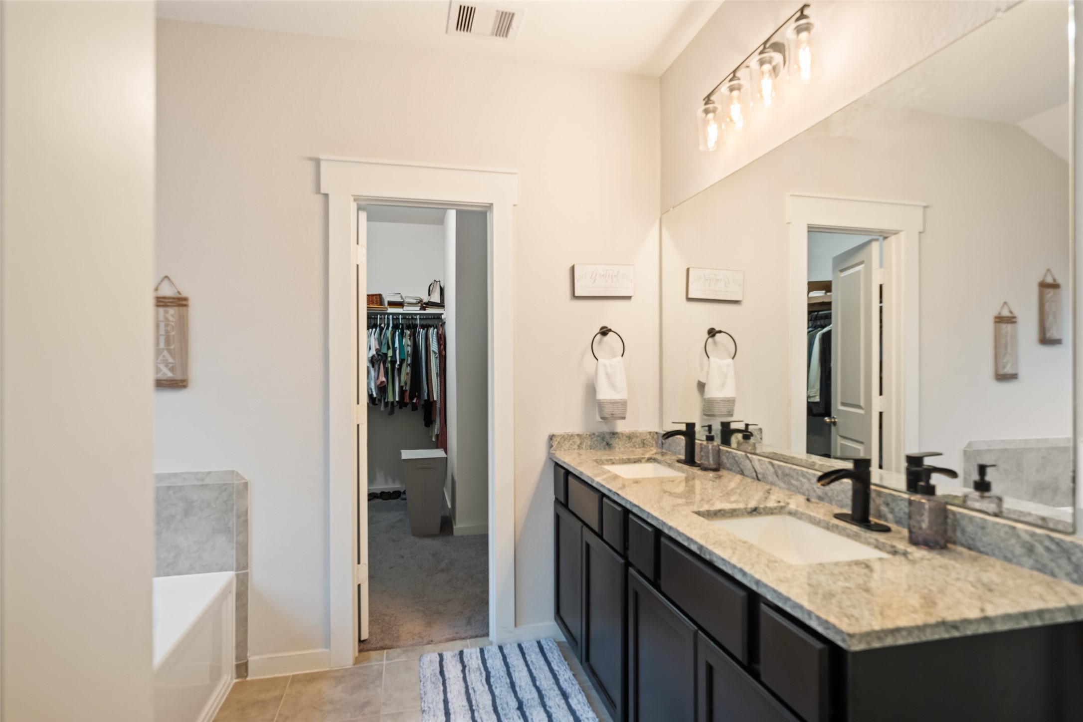 12158 Mustang Avenue Willis, TX 77378 - Photo 20 of 36 a bathroom with a granite countertop sink and a mirror