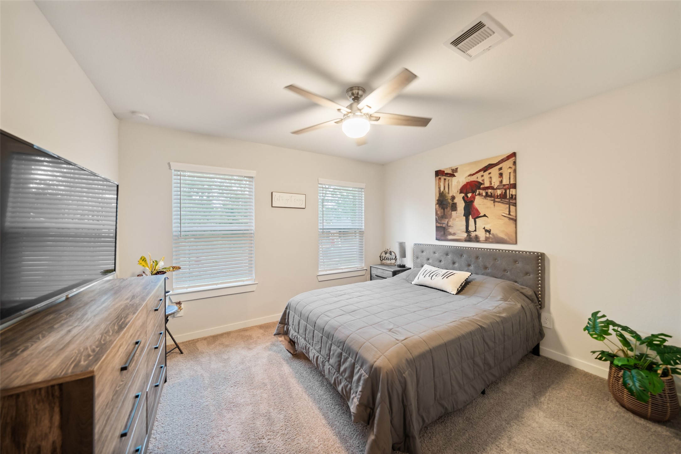 12158 Mustang Avenue Willis, TX 77378 - Photo 22 of 36 a bedroom with a bed and a chandelier