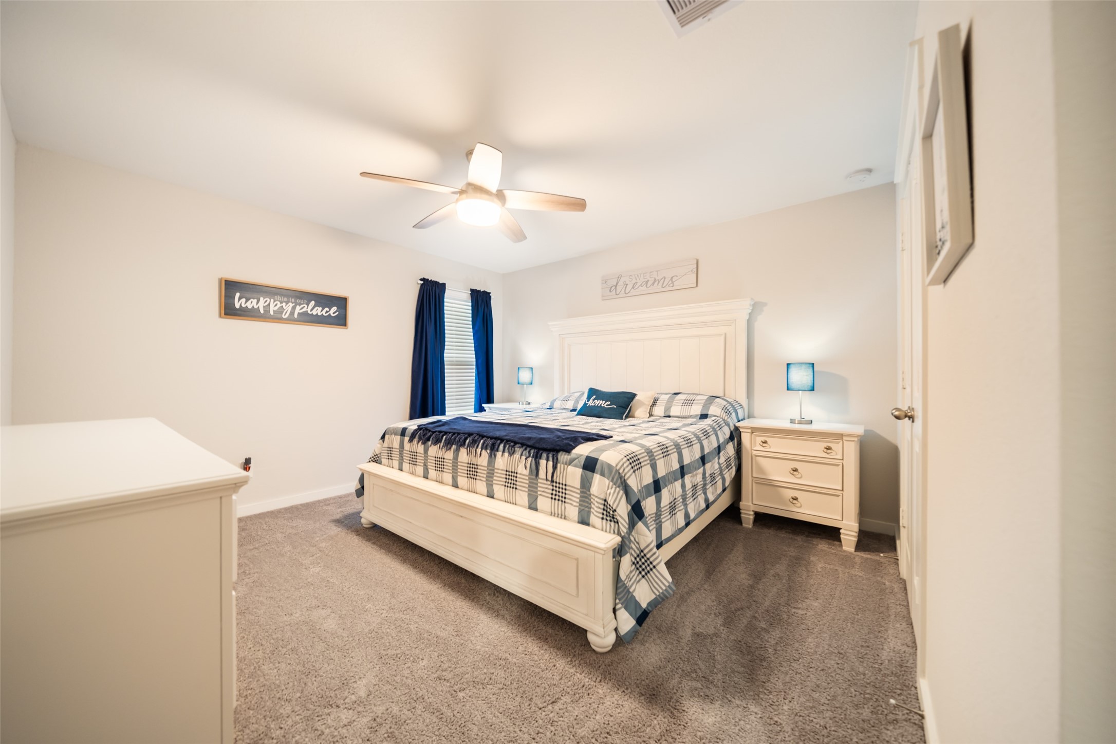 12158 Mustang Avenue Willis, TX 77378 - Photo 34 of 36 a spacious bedroom with a bed and a chandelier