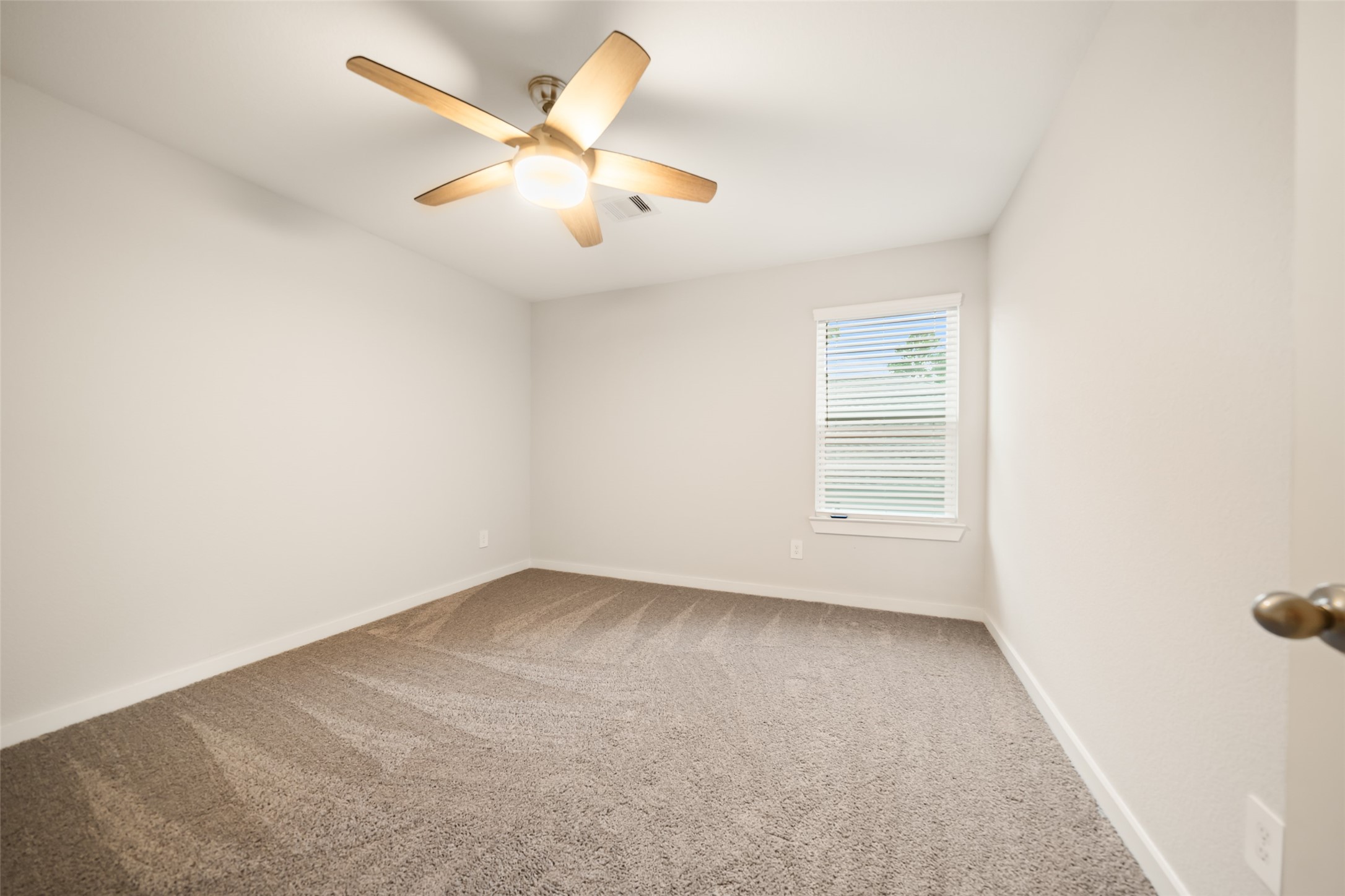 12158 Mustang Avenue Willis, TX 77378 - Photo 35 of 36 an empty room with a ceiling fan and window