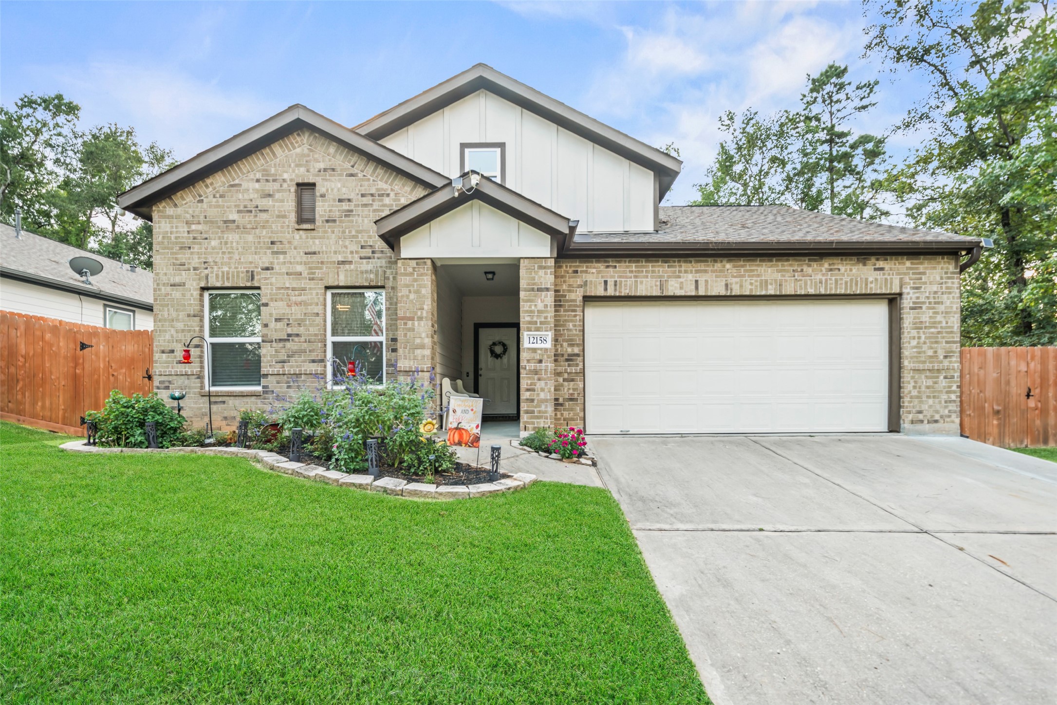 12158 Mustang Avenue Willis, TX 77378 - Photo 5 of 36 a front view of a house with a yard and garage