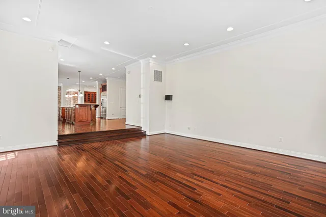 a kitchen with stainless steel appliances granite countertop wooden floors and sink