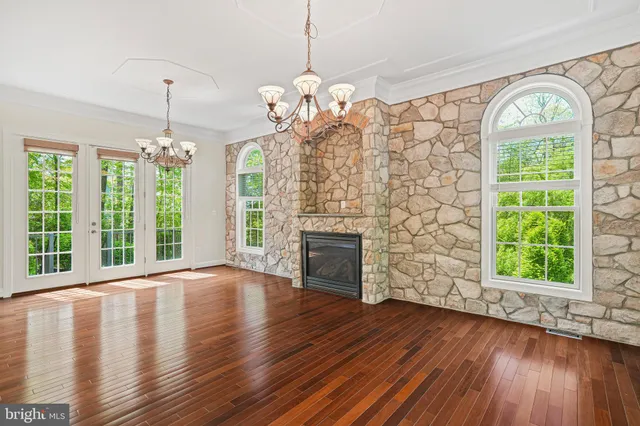 an empty room with windows and cabinet