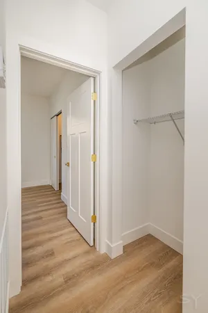 a view of a hallway with wooden floor