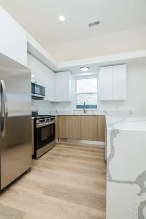 a kitchen with wooden cabinets and stainless steel appliances