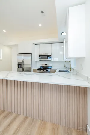 a kitchen with stainless steel appliances a sink and cabinets