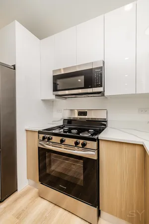 a stove top oven sitting inside of a kitchen