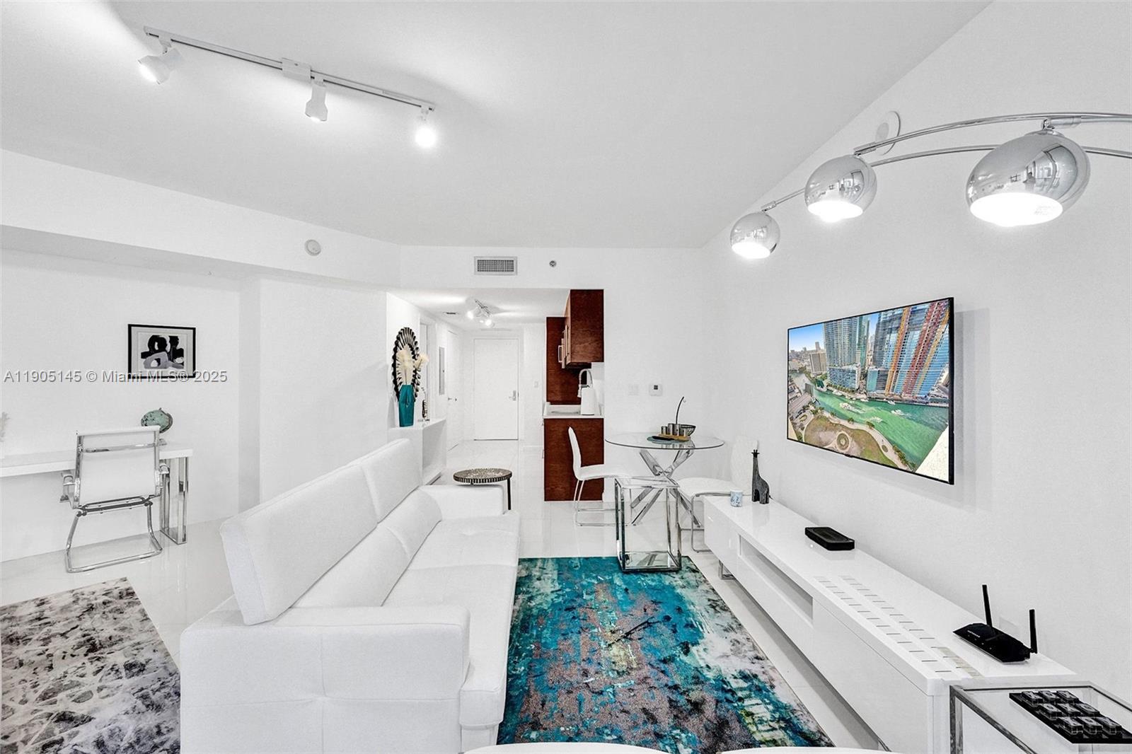 475 Brickell Avenue, Unit 2708 Miami, FL 33131 - Photo 11 of 20 a living room with furniture and a flat screen tv