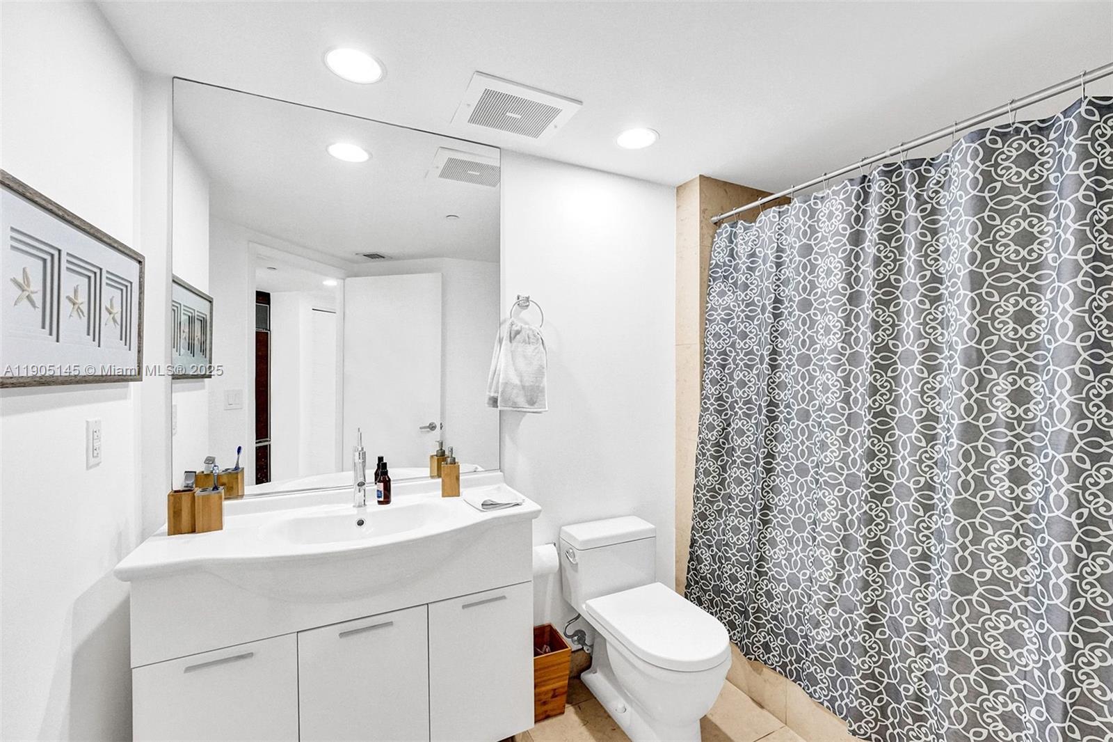 475 Brickell Avenue, Unit 2708 Miami, FL 33131 - Photo 12 of 20 a bathroom with a sink toilet and shower