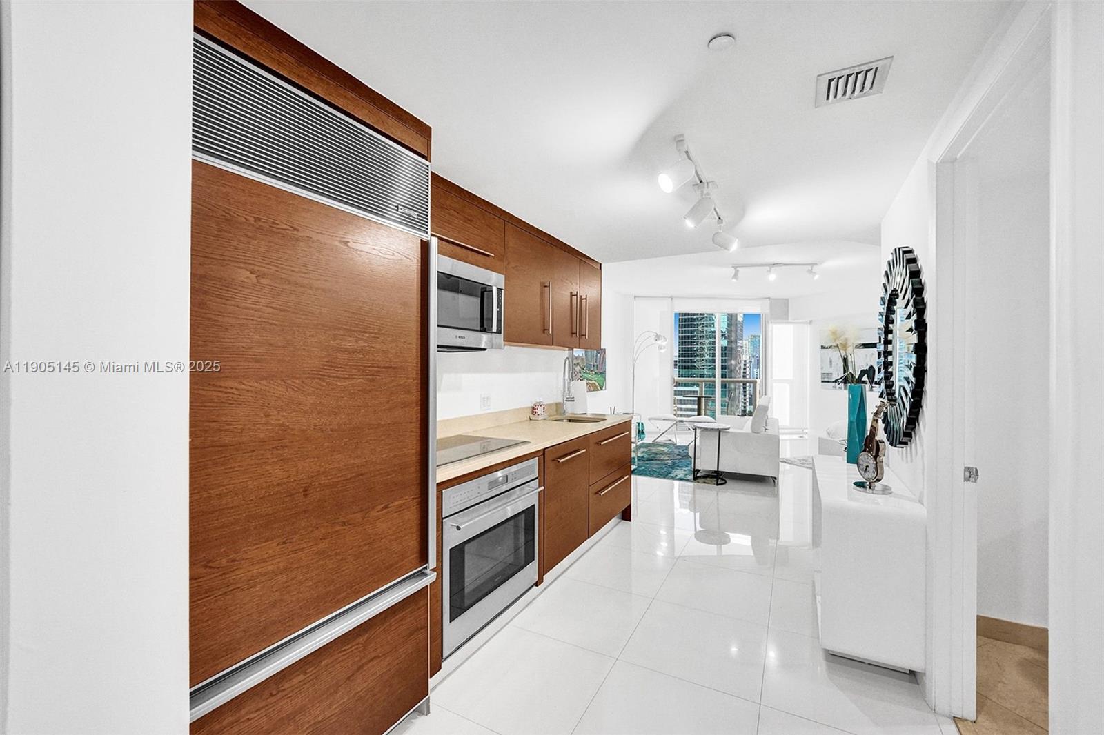 475 Brickell Avenue, Unit 2708 Miami, FL 33131 - Photo 7 of 20 a large white kitchen with a large window
