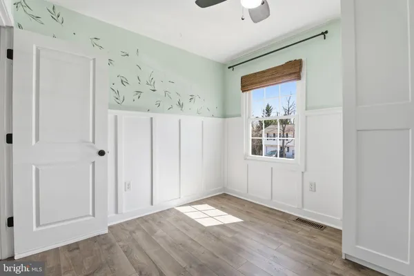 a view of a room with wooden floor and windows