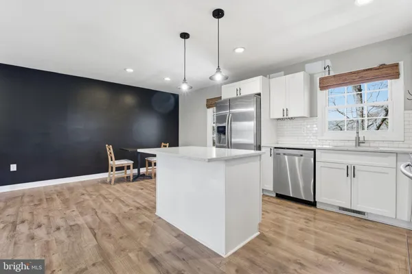 a kitchen with a sink cabinets and window