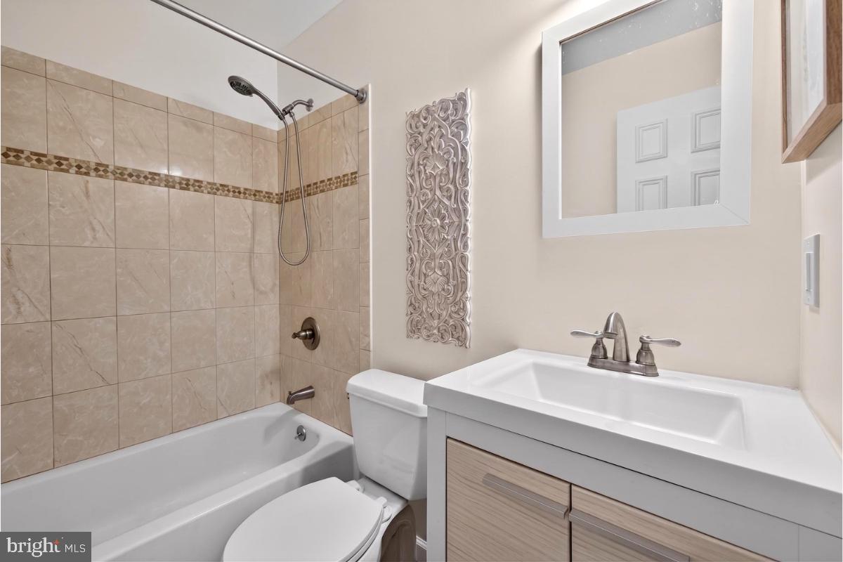 7347 Swan Point Way, Unit 122 Columbia, MD 21045 - Photo 33 of 54 a bathroom with a sink a toilet and shower