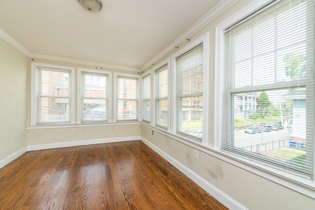 50-52 Townsend Street Boston, MA 02119 - Photo 13 of 15 a view of an empty room with wooden floor and a window