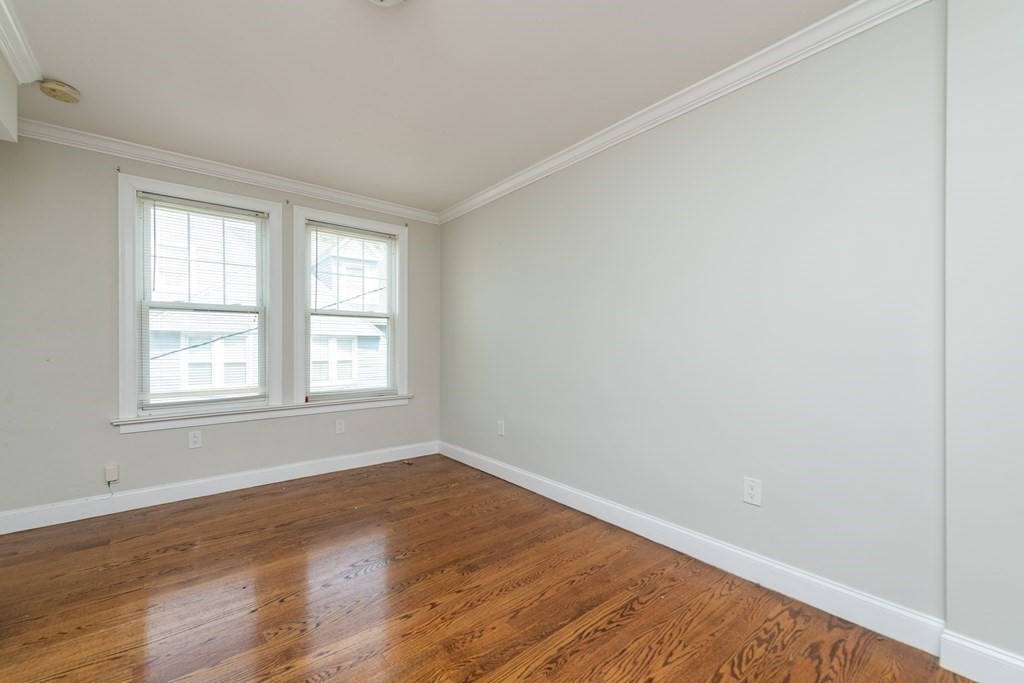 50-52 Townsend Street Boston, MA 02119 - Photo 14 of 15 an empty room with wooden floor and windows