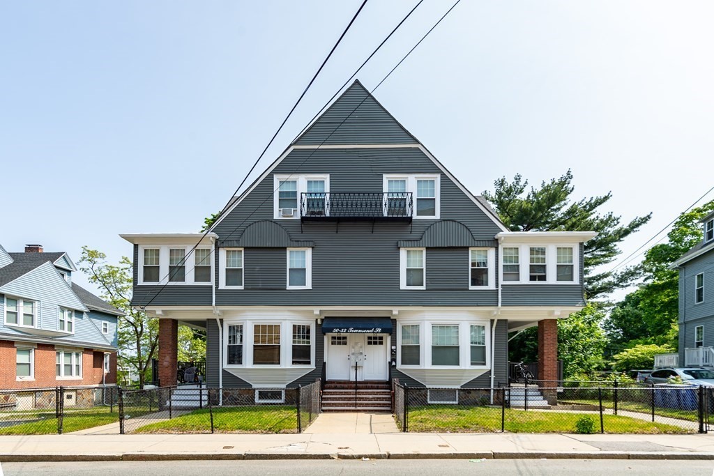 50-52 Townsend Street Boston, MA 02119 - Photo 2 of 15 a front view of residential houses with yard and green space