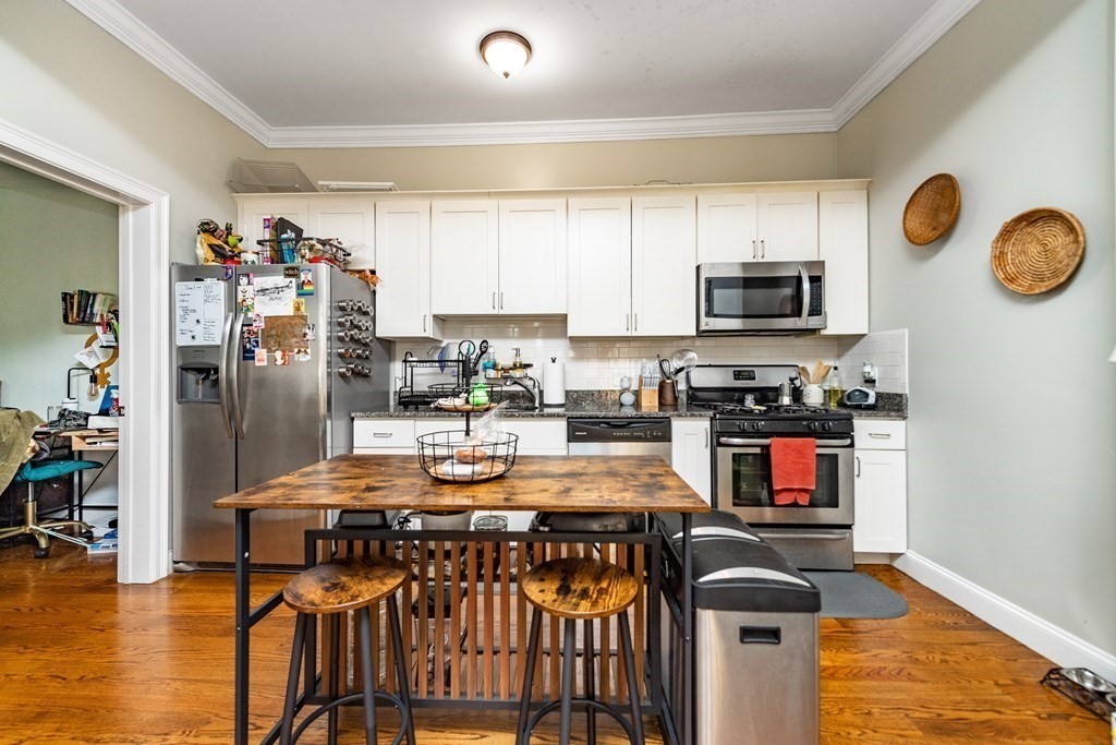 50-52 Townsend Street Boston, MA 02119 - Photo 8 of 15 a kitchen with stainless steel appliances a stove a refrigerator a stove top oven a sink and dishwasher