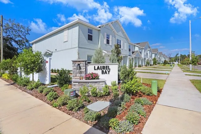a front view of a house with a yard and outdoor seating