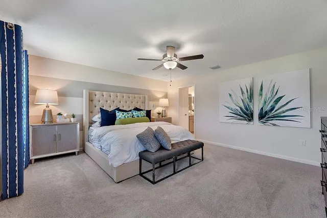 a bed room with a bed and a chandelier