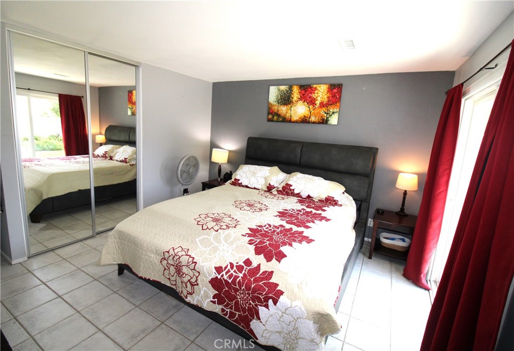 10113 Devon Street Rancho Cucamonga, CA 91730 - Photo 17 of 37 a bedroom with a bed and a chandelier