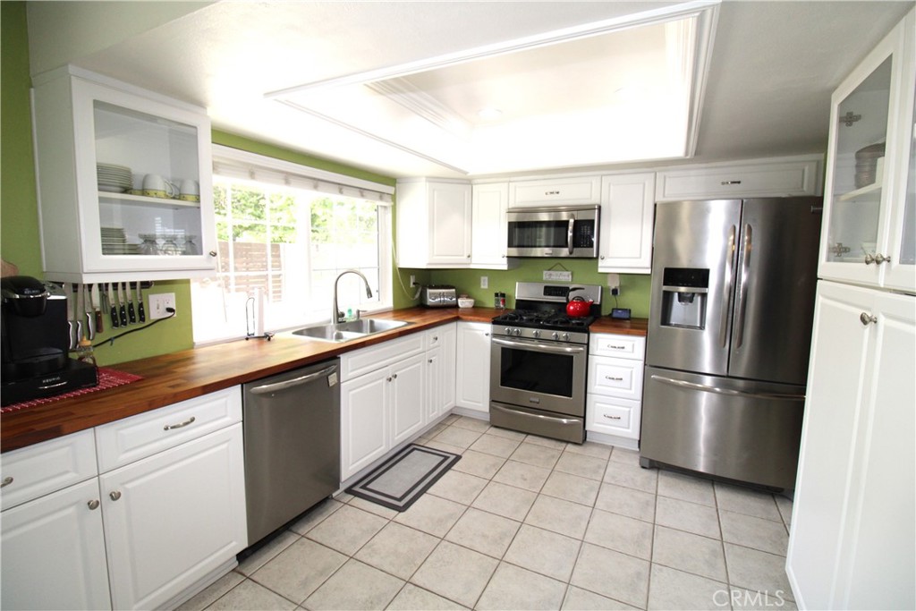 10113 Devon Street Rancho Cucamonga, CA 91730 - Photo 9 of 37 a kitchen with stainless steel appliances granite countertop a refrigerator sink and stove