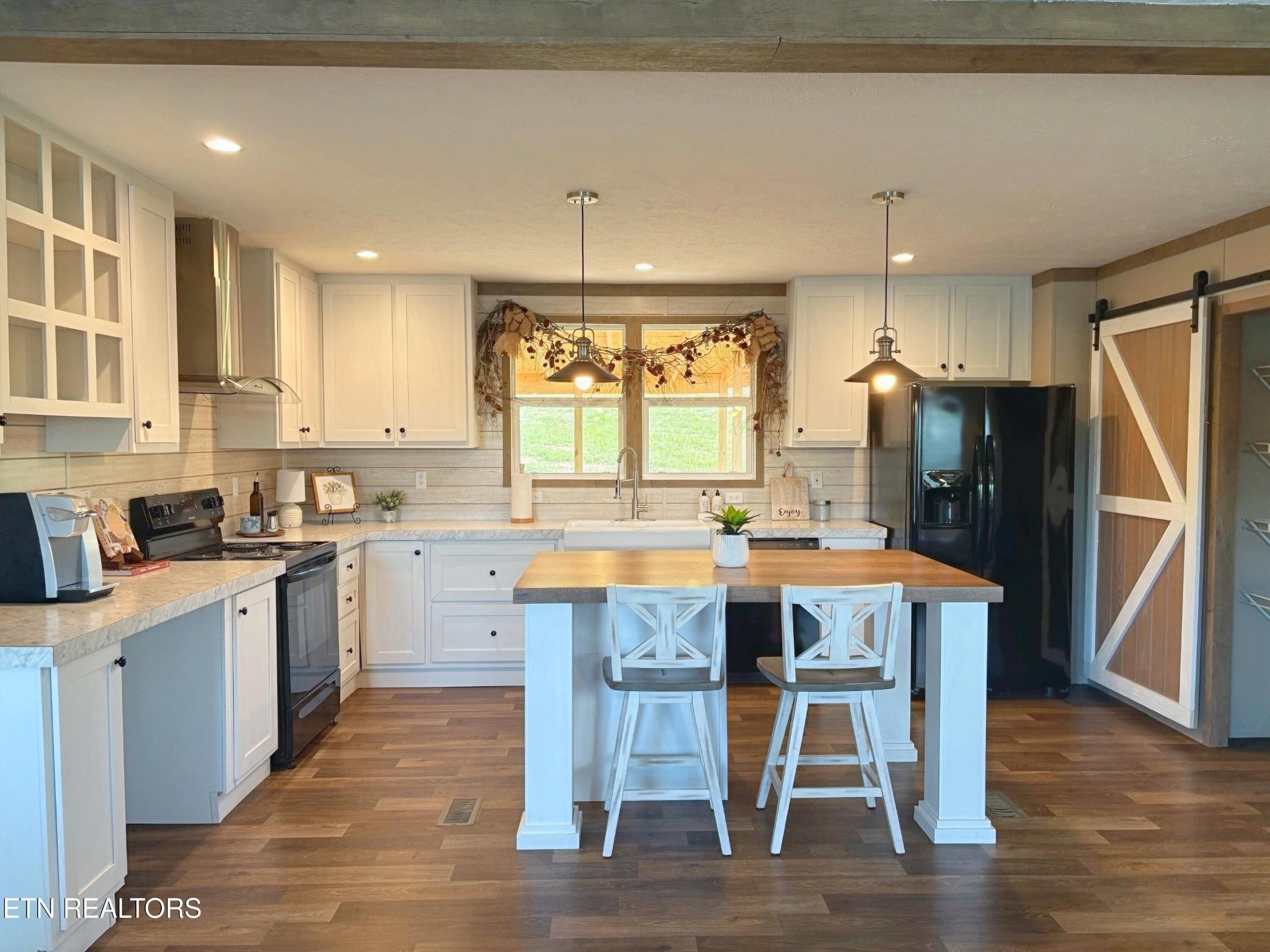 4501 Shipe Road Corryton, TN 37721 - Photo 5 of 32 a kitchen with a table chairs refrigerator microwave and cabinets
