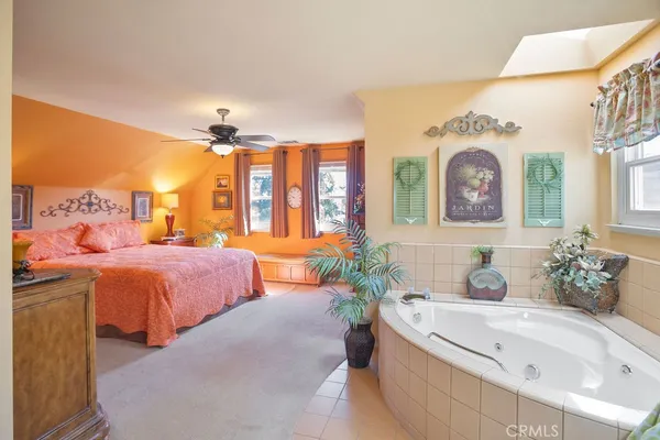 a spacious bedroom with a bed and a window