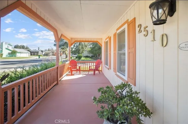 a view of a porch with furniture and garden