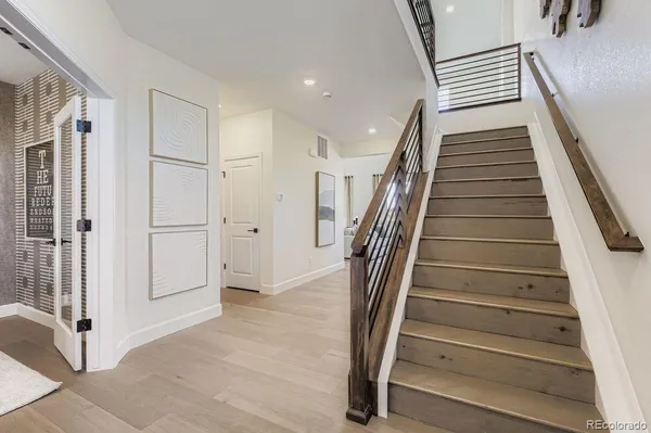 a view of entryway with wooden floor and stairs