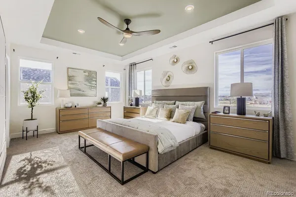a spacious bedroom with a bed and a couch