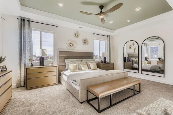 a bedroom with a bed and a large window